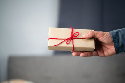 Midsection of man holding paper in box