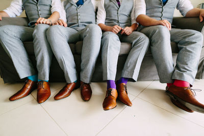 Low section of people sitting on sofa