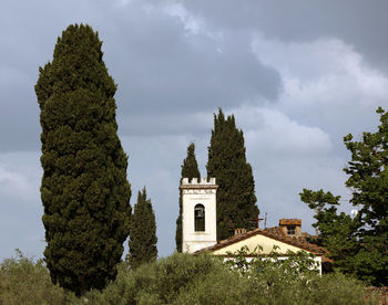 Low angle view of church and trees against sky