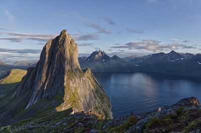 Panoramic view of mountains and a fjord against sky during sunset