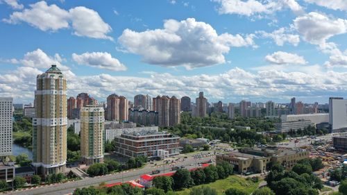 Aerial view of buildings in city against sky