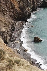 High angle view of rocks on sea shore