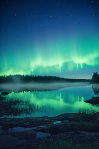 Scenic view of river against sky at night