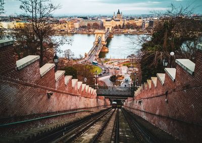 High angle view of railroad tracks amidst buildings in city