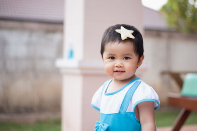 Portrait of cute girl standing outdoors