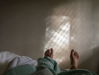 Low section of man relaxing on floor