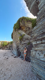 Woman standing on rock formation