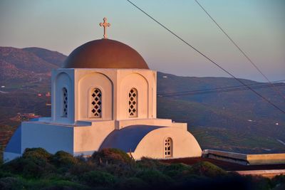 Church by building against sky