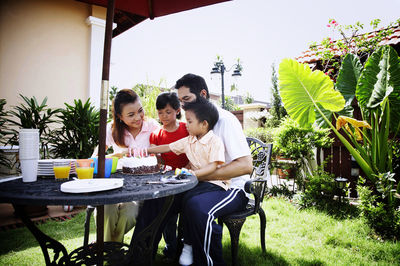 Family celebrating birthday in lawn