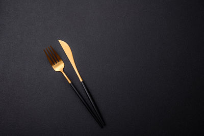 High angle view of chopsticks against black background