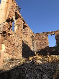 Low angle view of historical building against blue sky