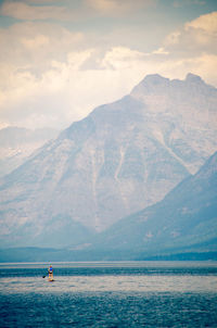 Scenic view of sea and mountains against sky