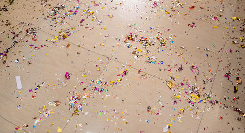 Low angle view of multi colored balloons against gray background