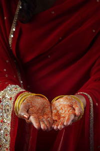 Midsection of woman showing henna tattoo