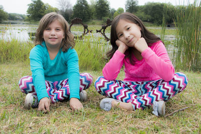 Portrait of a smiling girl sitting on grass