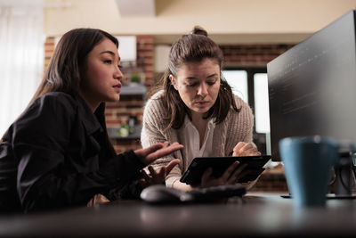 Businesswoman using laptop at table