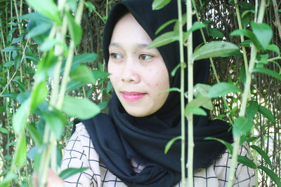 Portrait of smiling woman with plants