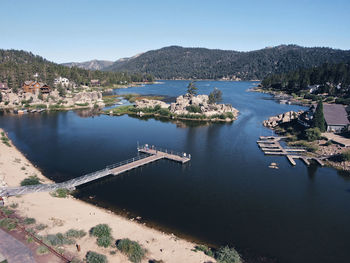 Scenic view of river by mountains against clear sky