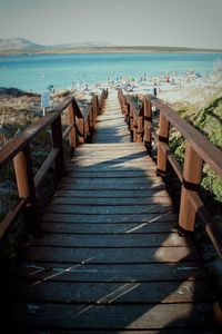 Boardwalk on beach against clear sky