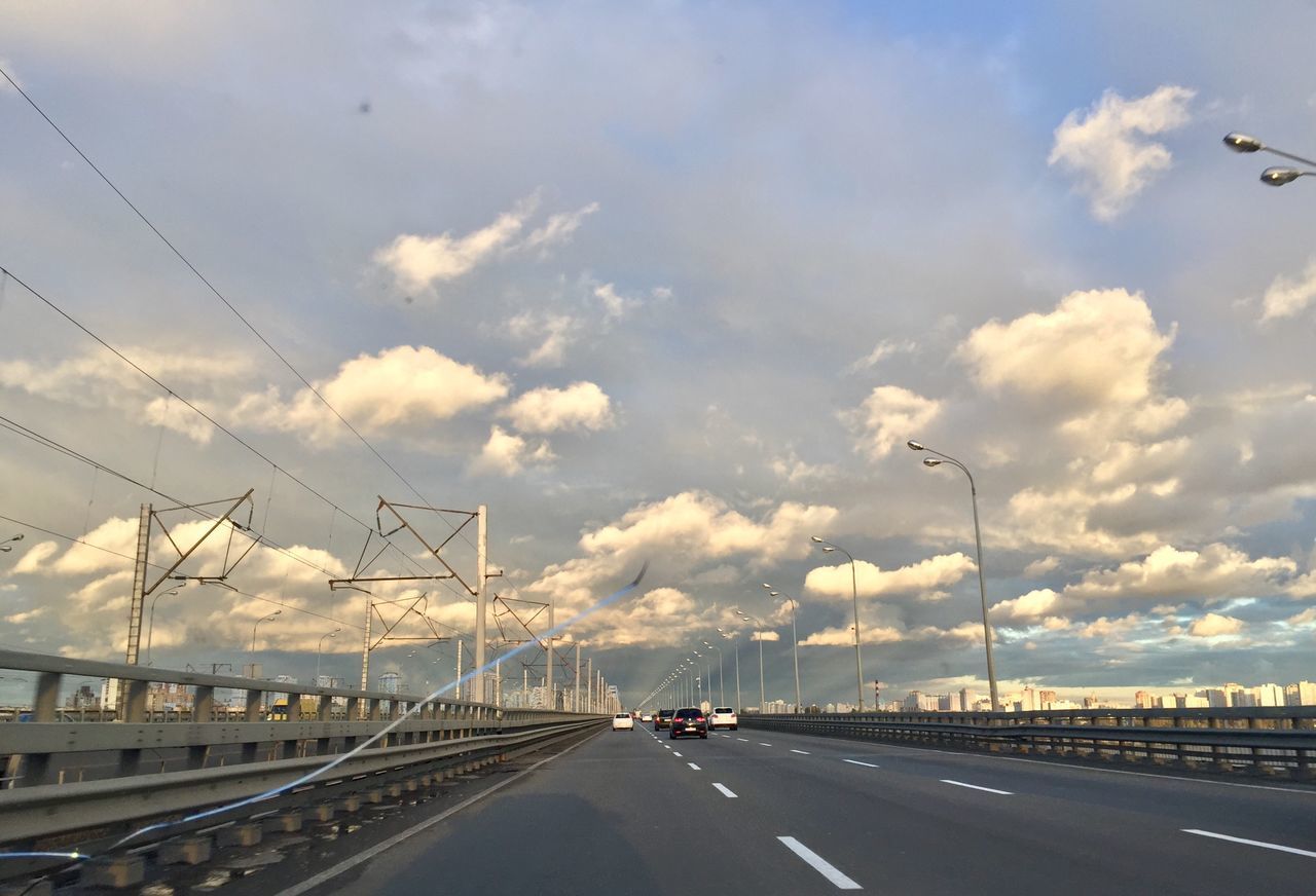 road, sky, transportation, cloud - sky, motor vehicle, sign, car, mode of transportation, street, nature, the way forward, direction, city, no people, highway, connection, symbol, architecture, land vehicle, road marking, outdoors, multiple lane highway, crash barrier