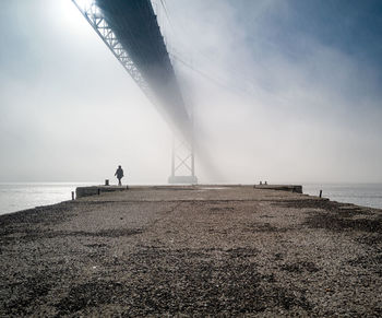 Man on beach against sky