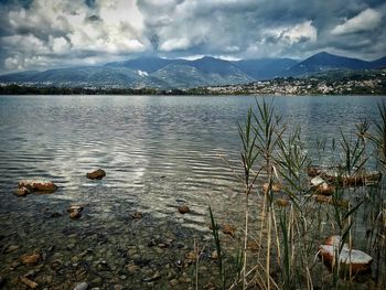 Scenic view of lake against cloudy sky