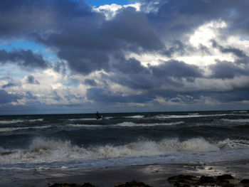 View of calm sea against cloudy sky