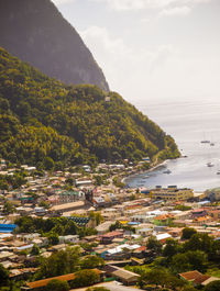 High angle view of town by sea against sky
