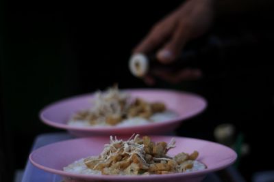 Close-up of hand holding salad in bowl