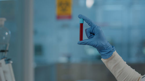 Cropped hand of man holding thermometer