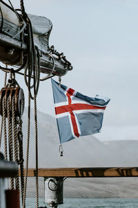 Low angle view of flags on pole against sky