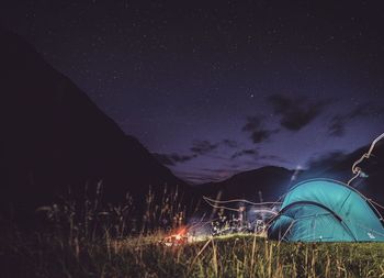 Tent on field against sky at night