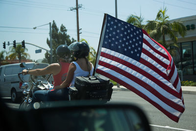 Midsection of man with flag in bus