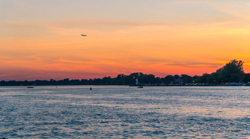 Scenic view of sea against orange sky