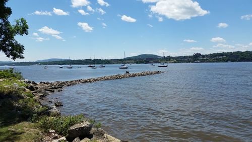 Scenic view of river against cloudy sky