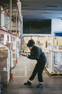 Side view of man standing in building