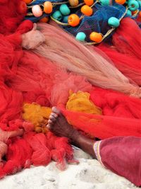 High angle view of woman among colorful textiles