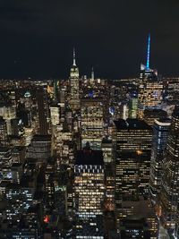 High angle view of city lit up at night