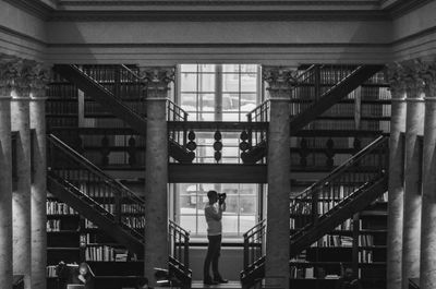 Man standing on staircase of building