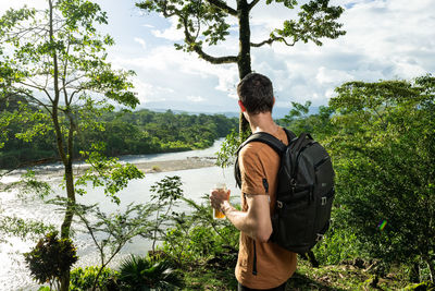 Happy hiker with a reusable drink bottle in man's hands. diabetic with freestyle libre 2 on the arm.