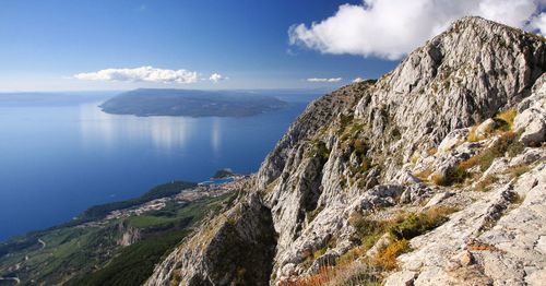 Panoramic view of sea and mountains against sky