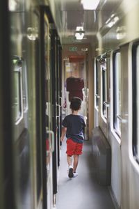 Rear view of child  in train