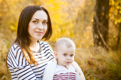 Portrait of mother and daughter during autumn