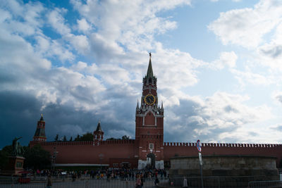 Buildings in city against cloudy sky
