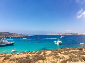 Boats in sea against clear sky
