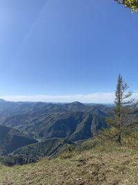 Scenic view of mountains against clear blue sky