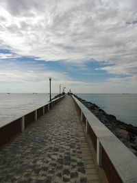 Pier over sea against sky