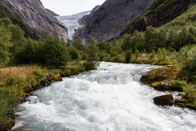 Scenic view of stream flowing through rocks