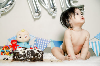 Cute baby girl sitting on table