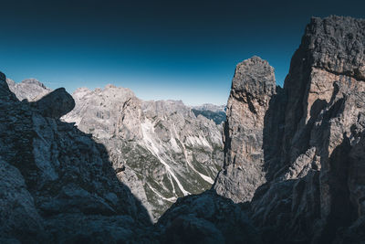 Scenic view of rocky mountains against clear blue sky